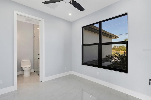 interior space featuring ensuite bathroom, ceiling fan, and light tile patterned flooring