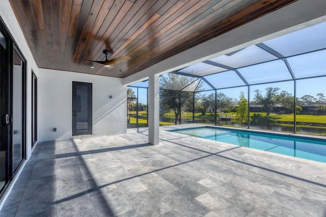 view of pool with ceiling fan, a patio area, a lanai, and a water view