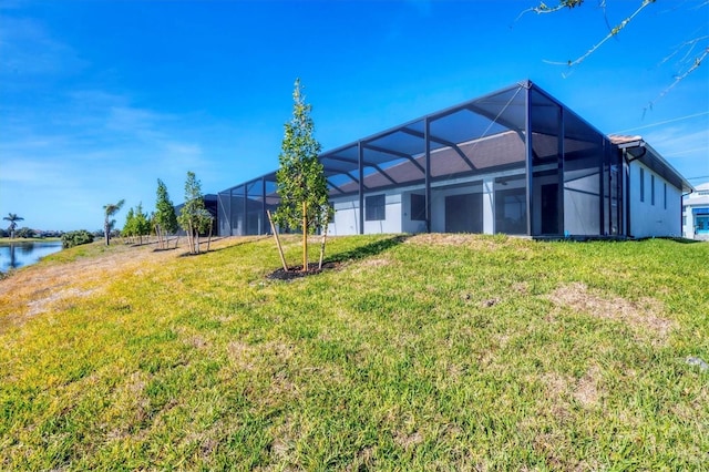 view of yard featuring a water view and glass enclosure