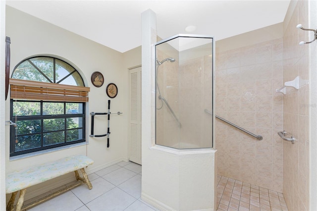 bathroom featuring tile patterned floors and a tile shower