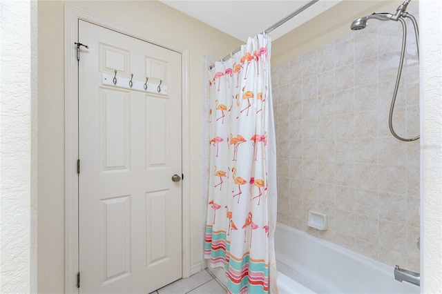 bathroom with tile patterned floors and shower / bath combo with shower curtain