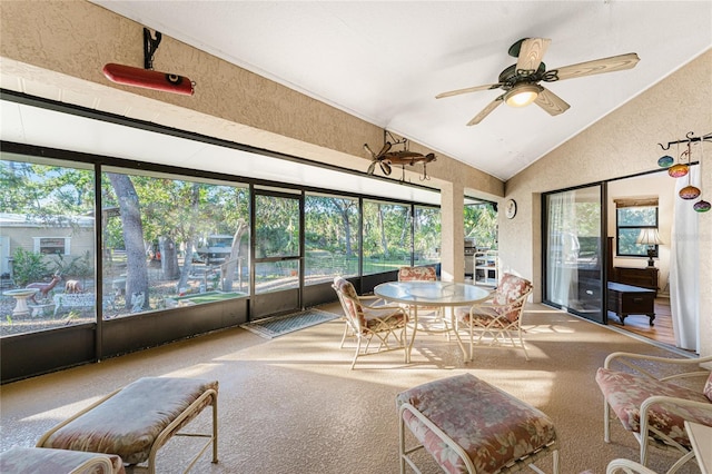 sunroom / solarium featuring vaulted ceiling, ceiling fan, and a healthy amount of sunlight