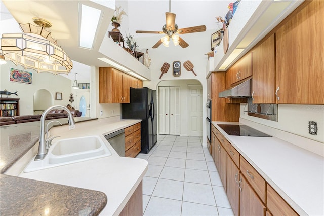 kitchen featuring kitchen peninsula, ceiling fan, sink, black appliances, and light tile patterned floors