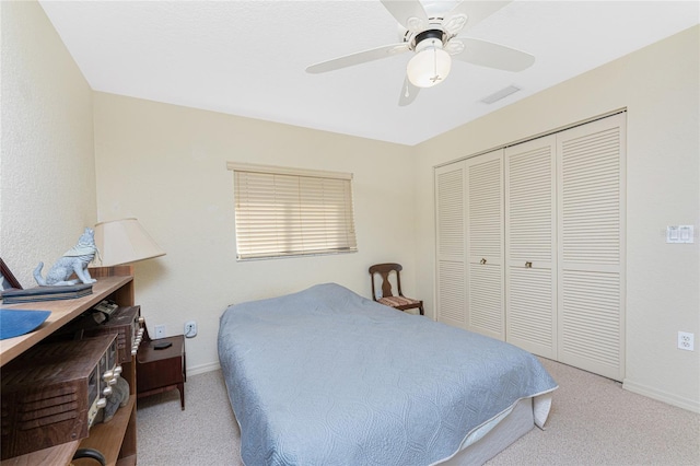 bedroom with light carpet, a closet, and ceiling fan