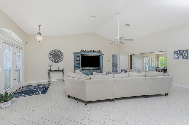 living room featuring ceiling fan, lofted ceiling, and light tile patterned flooring