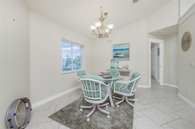 tiled dining room featuring a chandelier and lofted ceiling