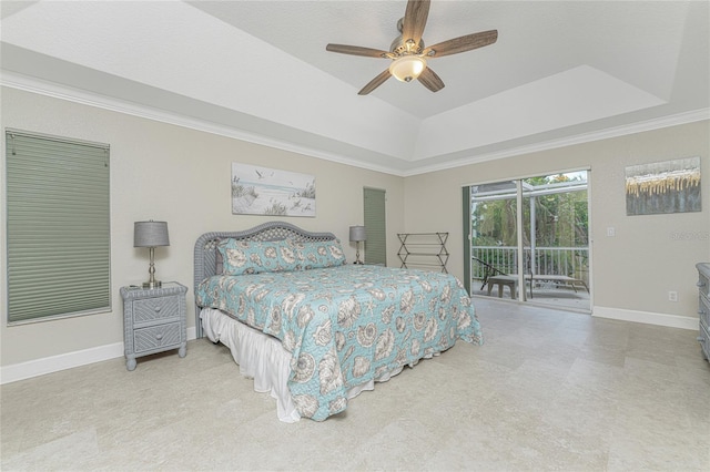 bedroom with access to exterior, a tray ceiling, ceiling fan, and ornamental molding