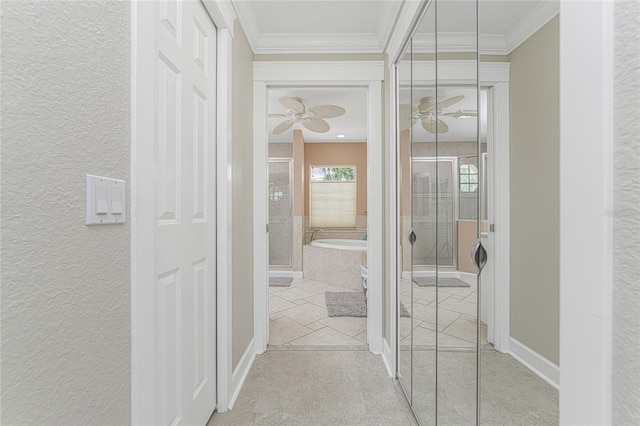 hallway with light tile patterned flooring and ornamental molding