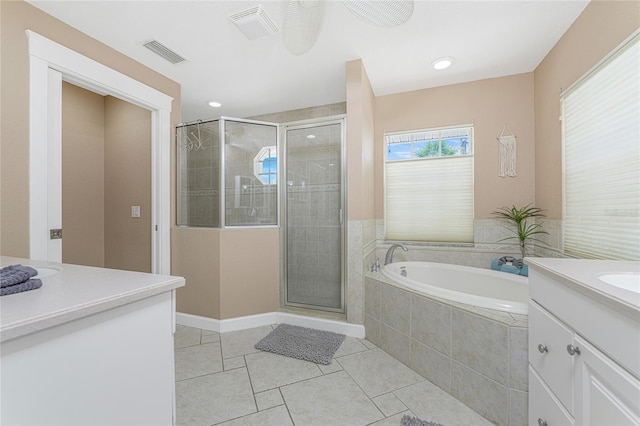 bathroom with tile patterned floors, vanity, and separate shower and tub