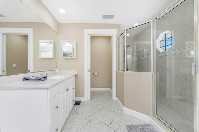 bathroom featuring tile patterned flooring, vanity, and an enclosed shower