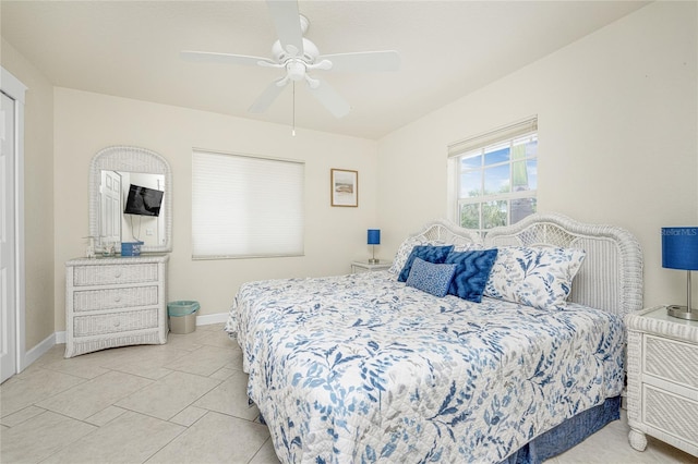 bedroom with ceiling fan and light tile patterned floors