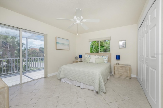 bedroom featuring access to outside, ceiling fan, a closet, and light tile patterned floors