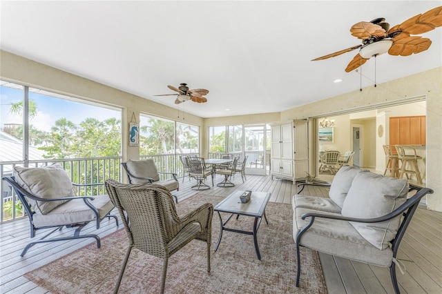 sunroom / solarium featuring ceiling fan