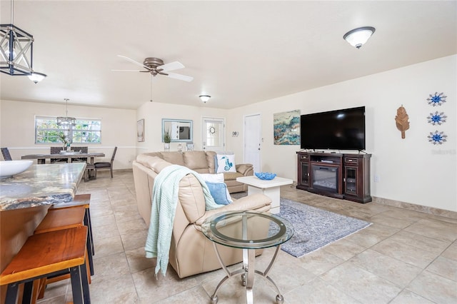 tiled living room featuring ceiling fan