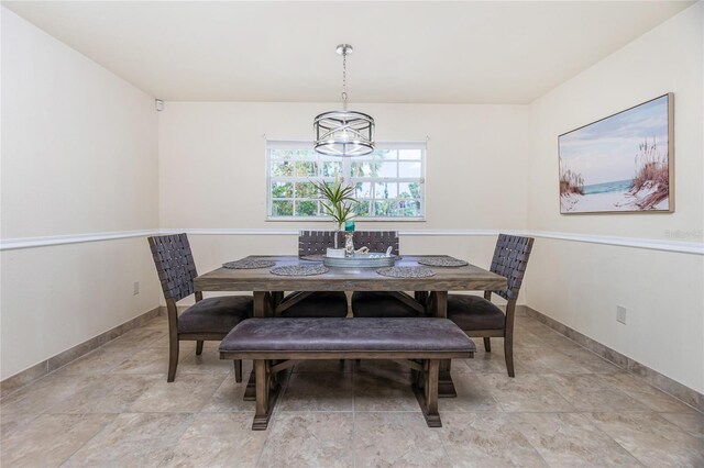 dining area featuring a notable chandelier