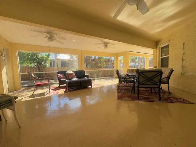 sunroom / solarium featuring ceiling fan and a wealth of natural light