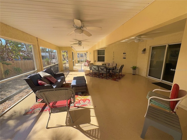 sunroom / solarium featuring ceiling fan