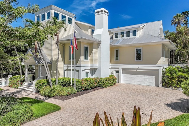 view of property with a porch and a garage