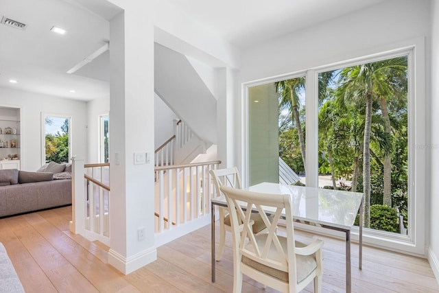 dining room with light hardwood / wood-style flooring and plenty of natural light