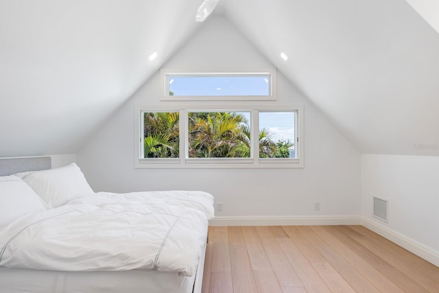 bedroom featuring vaulted ceiling and light hardwood / wood-style flooring