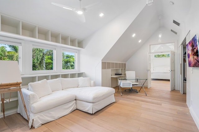 living room with ceiling fan, high vaulted ceiling, and light hardwood / wood-style flooring