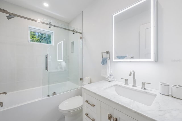 full bathroom featuring vanity, toilet, and combined bath / shower with glass door