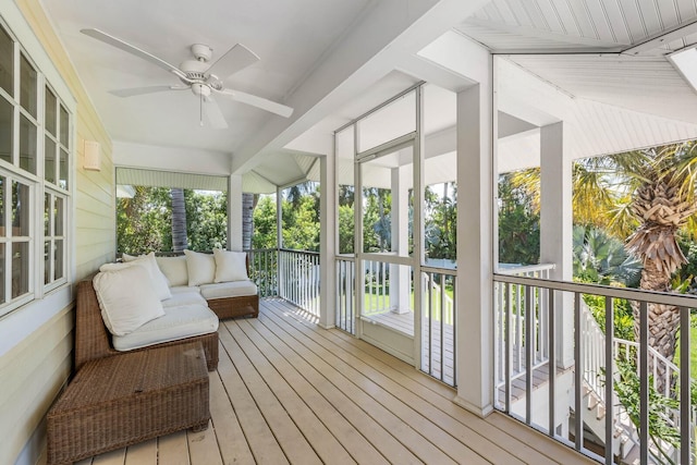 sunroom / solarium featuring ceiling fan