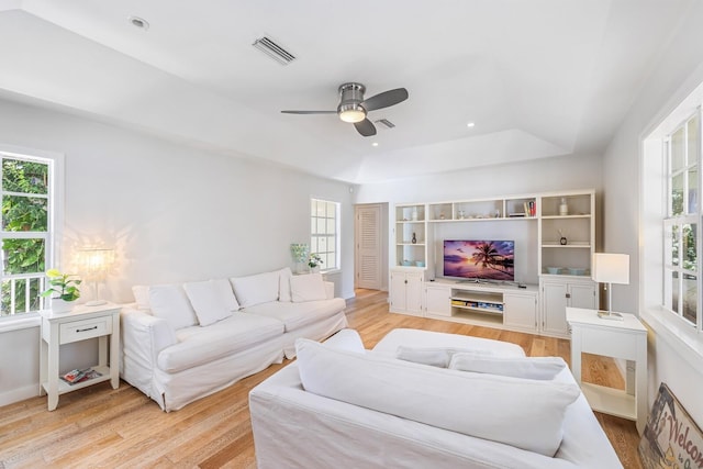 living room featuring ceiling fan, plenty of natural light, and light wood-type flooring