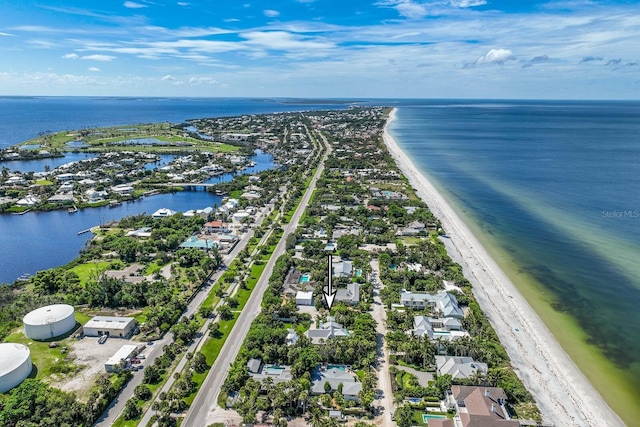 drone / aerial view featuring a water view and a view of the beach