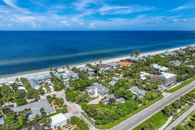 drone / aerial view featuring a water view and a beach view