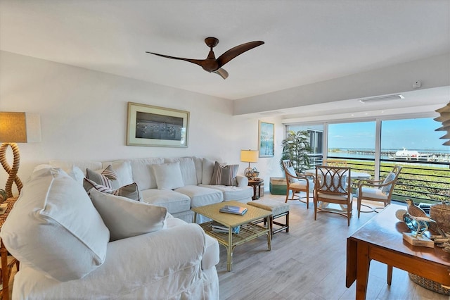 living room with ceiling fan and light hardwood / wood-style floors