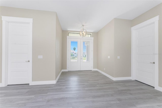 entryway with a chandelier and light hardwood / wood-style flooring