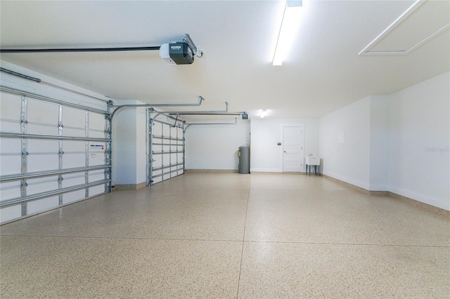 garage with electric water heater and a garage door opener