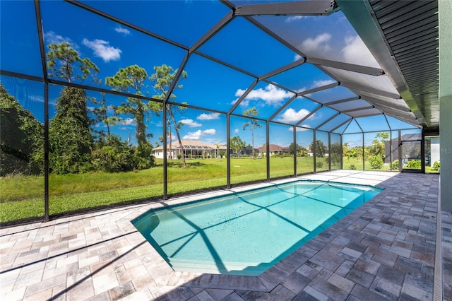 view of pool featuring a lanai, a patio area, and a yard