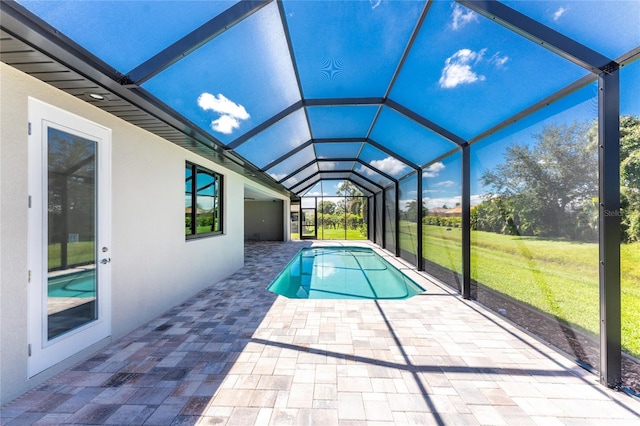 view of swimming pool with a lanai and a patio area