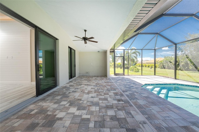 view of pool with a lanai, ceiling fan, and a patio