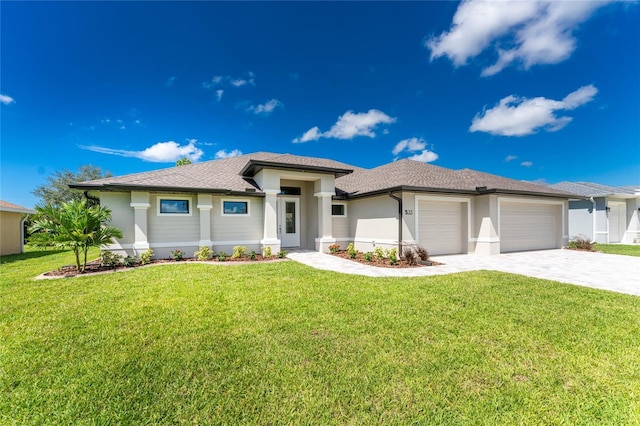 prairie-style home with a front lawn and a garage