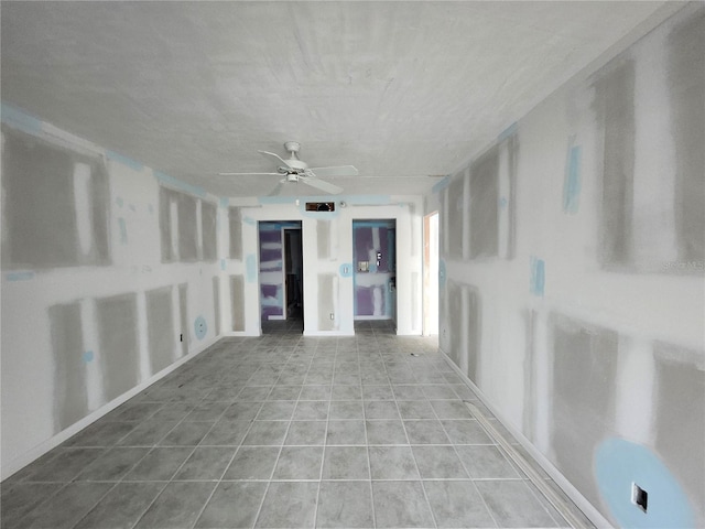 unfurnished sunroom featuring ceiling fan