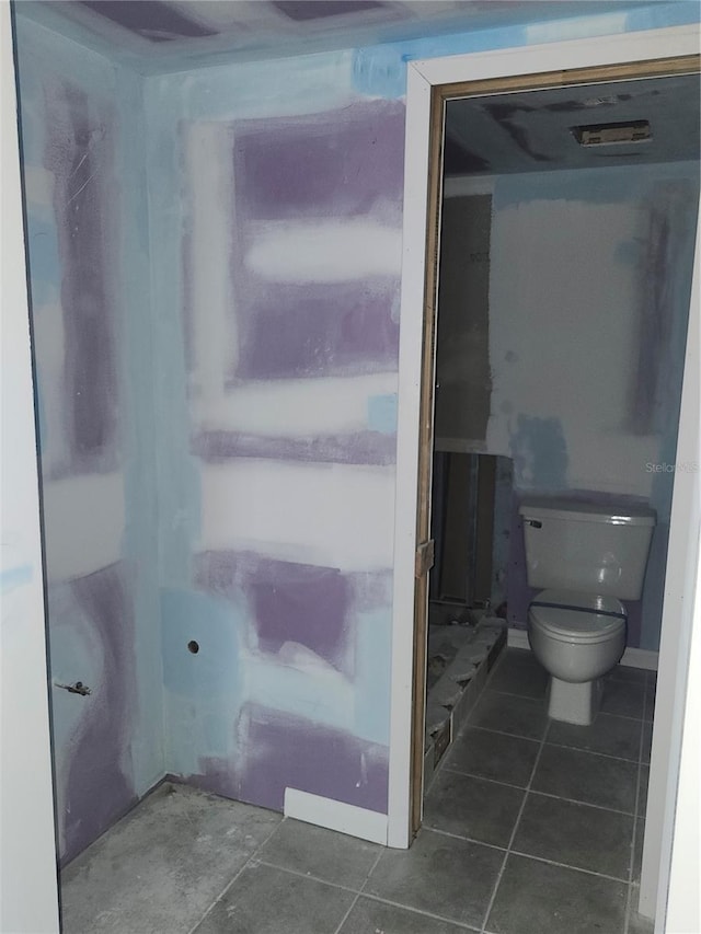 bathroom featuring toilet and tile patterned floors