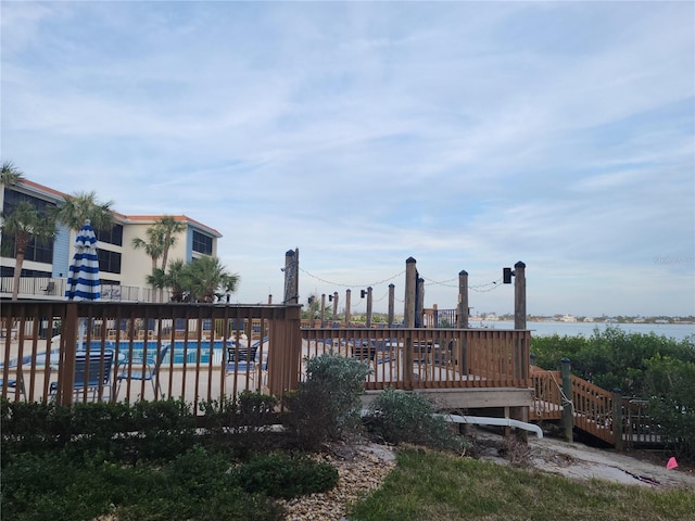 exterior space with a water view and a community pool