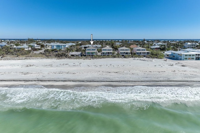 aerial view with a water view and a beach view