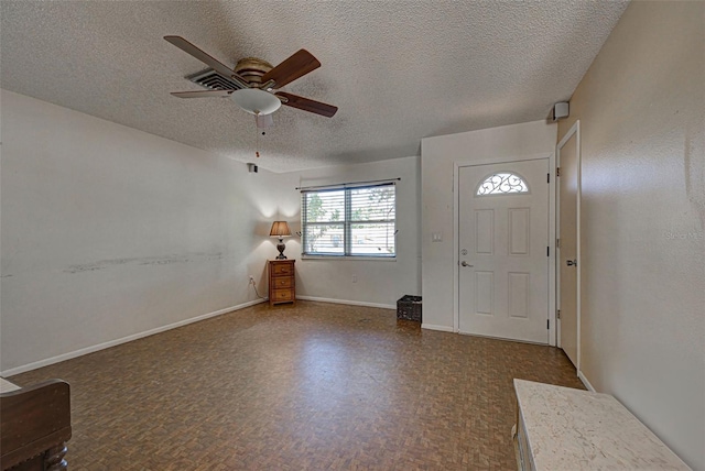 entrance foyer with a textured ceiling and ceiling fan