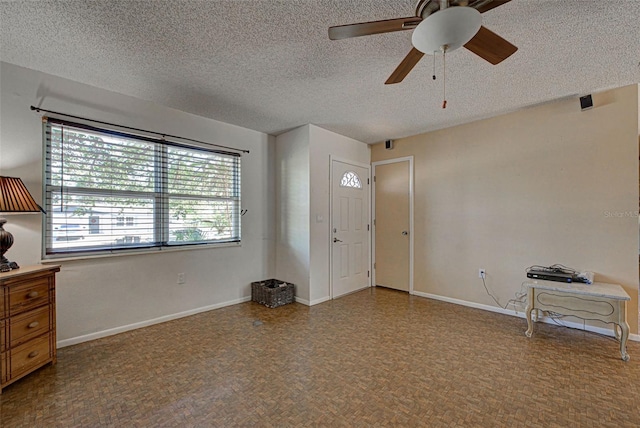 entrance foyer featuring a textured ceiling and ceiling fan