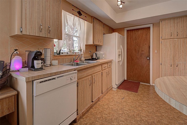 kitchen featuring decorative backsplash, light brown cabinets, white appliances, and sink