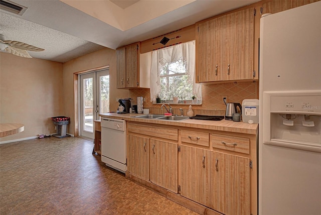 kitchen featuring white appliances, tasteful backsplash, light hardwood / wood-style flooring, and sink