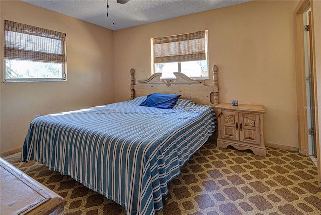 bedroom with carpet flooring, a textured ceiling, and ceiling fan