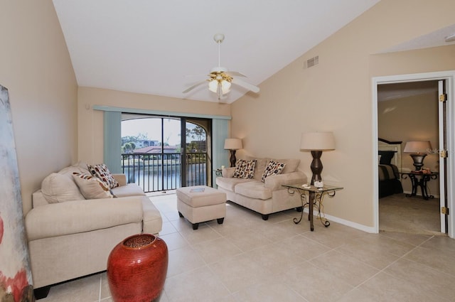 tiled living room featuring a water view, vaulted ceiling, and ceiling fan