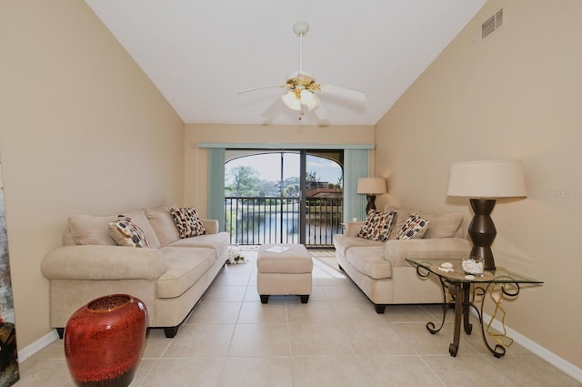 tiled living room with ceiling fan, a water view, and lofted ceiling