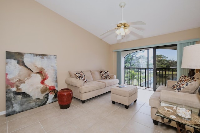 living room featuring ceiling fan, light tile patterned floors, a water view, and lofted ceiling