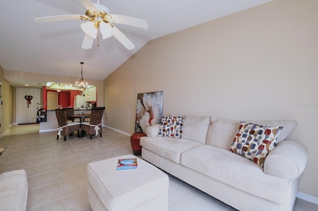 tiled living room featuring ceiling fan with notable chandelier and vaulted ceiling